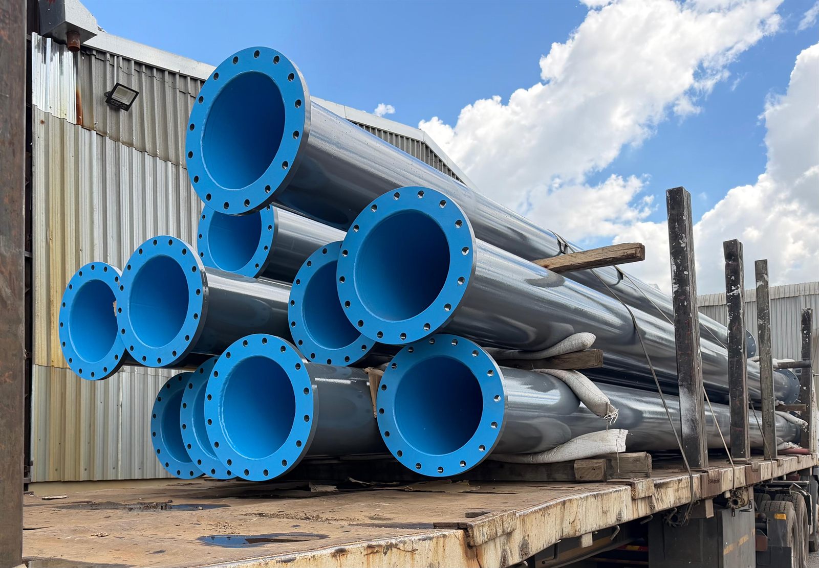 Fabricated flanged pipes prepared for delivery